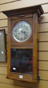 A polished pendulum wall clock with silvered dial and Arabic numerals Condition reports provided