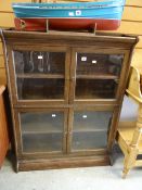 A vintage two-section glazed and oak library bookcase Condition reports provided on request by email