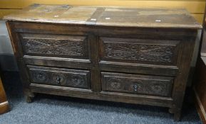 An unusual nineteenth century coffer chest having a carved facade with two drawers and a top with