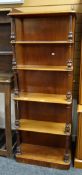 An unusual antique mahogany five-shelf whatnot with full length side cupboard and galleried top,