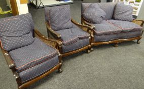 An early twentieth century three-piece bergere suite in later blue ground and pink motif decorated