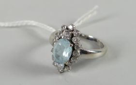 A modern diamond & blue stone floral ring with white metal setting Condition reports provided on