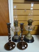 Two antique oil lamps, a pair of barley-twist candlestick holders Condition reports provided on