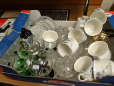 A box of glassware including green stemmed glasses, a black and clear glass liquor set together with