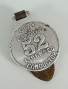 A white metal city of Cardiff bus or tram conductors badge, number 52 on leather strap