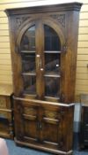 A good antique-reproduction standing corner cupboard with upper glazed section and based cupboard,