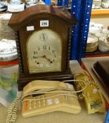 An early twentieth century German-type chiming mantel clock with arched glass covered silvered