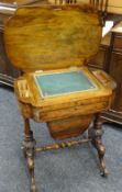 A nineteenth century walnut sewing table having a shaped top over a carved columnal base and with