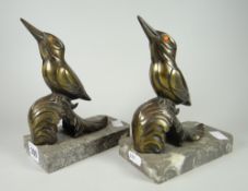 A pair of antique (believed) bronze kingfisher model bookends, perched on grey marble platform bases