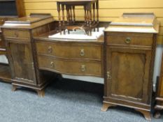 An Edwardian mahogany serpentine front break-top sideboard having two centre drawers, two flanking