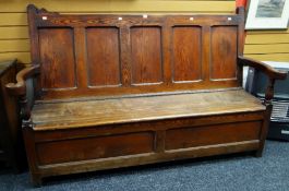 A good nineteenth century pitch pine settle, the base of two panels and back of five panels,