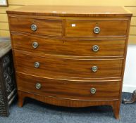 A neat antique bow front chest of three long and two short drawers with cross banding and rosette-