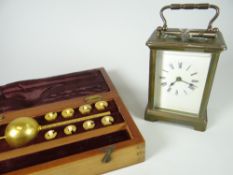A brass and glass carriage clock together with a vintage cased liquid measure set Condition