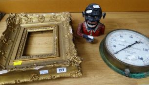 A novelty cast iron and politically incorrect money box together with a vintage brass encased