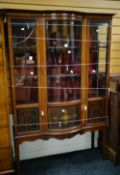 An Edwardian inlaid mahogany standing china cabinet with curved glass centre section and two