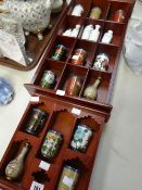Two wooden displays of twentieth century Oriental miniature cloisonne vases and miniature Republican