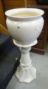 A modern cream pottery planter and matching pedestal Condition reports provided on request by