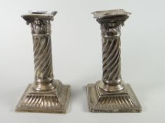 A pair of London silver architectural candlestick holders (loaded) Condition reports provided on