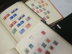 Four 'The Favourite Philatelic' albums of stamps, two blue similar, a red similar and another blue