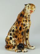 A painted pottery model of a seated leopard or cheetah, 34cms high (BBC Bargain Hunt) Condition