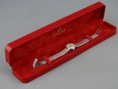 AN EIGHTEEN CARAT WHITE GOLD LADY'S OMEGA LADYMATIC WRISTWATCH having a circular dial and