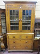 AN ANTIQUE WELSH OAK & PINE TWO PIECE CUPBOARD with Talwrn decoration, the upper section with twin