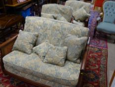 A FINE MID TONED ERCOL THREE PIECE BERGERE SUITE with green and fawn floral upholstery, (all
