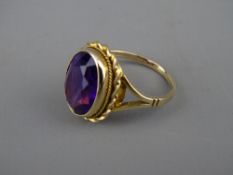A NINE CARAT GOLD DRESS RING with oval amethyst in a twist setting, 1.9 x 1.3 cms, 4.7 grms, size '