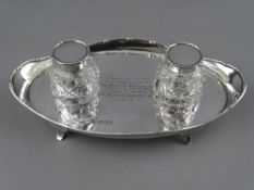 A SILVER OVAL SHAPED TWO BOTTLE INKSTAND with presentation inscription, London 1921, 5.1 troy ozs