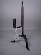 A TRIPOD STEEL RUSH LIGHT HOLDER on three pad supports, 29 cms high