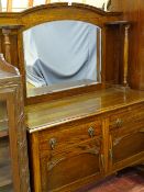 A POLISHED MIRROR BACKED SIDEBOARD the top having shelved pillars to a base of two drawers and two