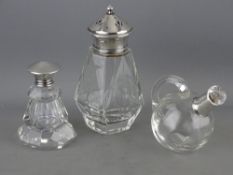A GLASS OIL BOTTLE WITH SILVER BANDED COLLAR and two other glass containers, each with a silver