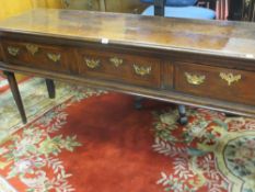 A GEORGE III OAK SHROPSHIRE DRESSER BASE of excellent colour having a two plank moulded edge top