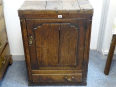 AN 18th CENTURY OAK CUPBOARD having a single applied panelled door with flanking quarter cut pillars