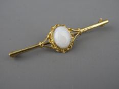 A NINE CARAT GOLD BAR BROOCH with oval centre opal in a twist mount, 1 x 0.8 cms, 3.4 grms gross