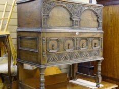 A VINTAGE JACOBEAN STYLE OAK CHEST ON STAND, the rectangular top with beaded edging, iron lock and