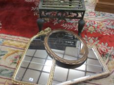 A PARCEL OF THREE MIRRORS - oval and two oblong, all with gilt frames and an antique steel footman