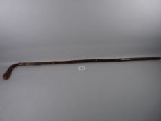 A LADY'S STAINED LIGHT WOODEN WALKING CANE with silver band