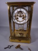 A FRENCH FOUR GLASS, BRASS CASED MANTEL CLOCK, white enamel dial with visible escapement, set with