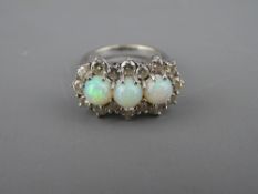 AN EIGHTEEN CARAT WHITE GOLD OPAL & DIAMOND CLUSTER DRESS RING having three round cut opals in an