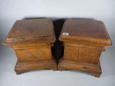 A PAIR OF CONTINENTAL WALNUT URN STANDS, square stepped format with corner bracket feet, 30 cms