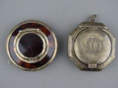 AN OCTAGONAL SILVER COMPACT with hinged and mirrored lid (some impact un-evenness to the back) and a