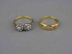AN UNMARKED GOLD TWIN CLUSTER DIAMOND RING, each cluster having a centre stone of visual estimate