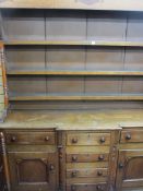 A 19th CENTURY ANGLESEY OAK & MAHOGANY BREAKFRONT DRESSER, the three shelf wide boarded rack with