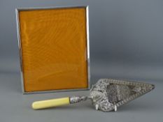 A SILVER PHOTOGRAPH FRAME, Birmingham 1972 and a silver plated presentation trowel dated November