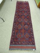 A MESHWENI CARPET RUNNER, blue and red ground with repeating central diamond pattern and single