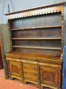 A LATE 19th CENTURY OAK & MAHOGANY WELSH DRESSER having a pierced and patterned hood over three