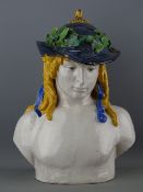 AN ITALIAN TERRACOTTA POTTERY MAJOLICA BUST of a young man with flowing golden hair and garland hat,