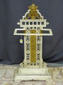 A CIRCA 1900 CAST IRON STICKSTAND with mask and floral detail, drip tray intact, 85 cms high, 45 cms
