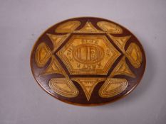 AN OVAL BONE BOX with inlaid lid bearing as follows 'Sige of Namyr, 1897' and containing three red